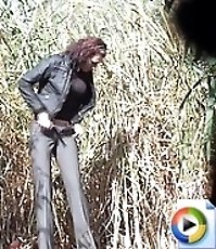 Gals squat down together to pee on trash