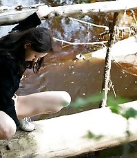 Spy busts a hot young chick pissing into the river