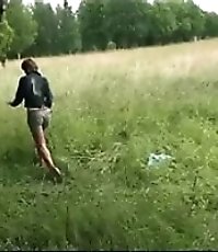 Girl peeing near the car