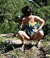 Skinny ravenhead urinating next to a picnic table