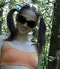 Pigtailed babe in dark glasses wees in quiet park