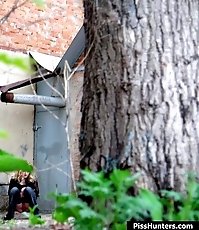 Sexy blondie empties her bladder behind a building