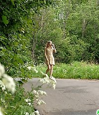 Nude cutie tinkles on the shoulder of country road