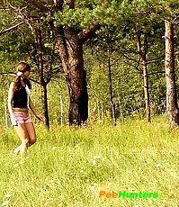 Pig-tailed puss sits down to take a quick leak