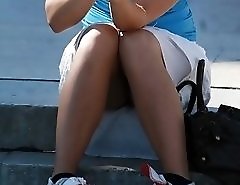 Smoking blonde in mini spyed, up skirt sitting